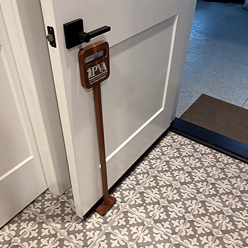 Wide-automatic-hotel-entrance-door-with-a-wheelchair-and-mobility-scooter-passing-safely,-illustrating-accessibility-and-inclusive-design